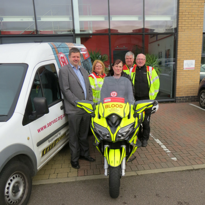 SERVCS volunteers with motorcycle